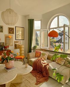 a living room filled with furniture and lots of windows