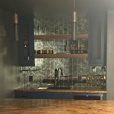 a kitchen with wooden counter tops and blue cabinets