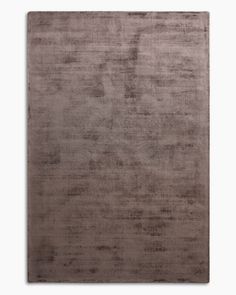 an area rug that is made out of various materials and colors, including brown tones