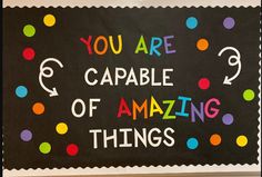 a bulletin board with the words you are capable of amazing things written in multicolored dots