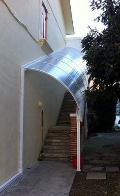 an arch leading up to a house with stairs