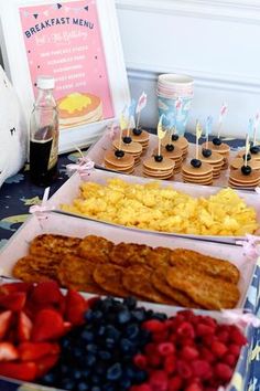 an assortment of breakfast foods on display at a baby's first birthday party or brunch