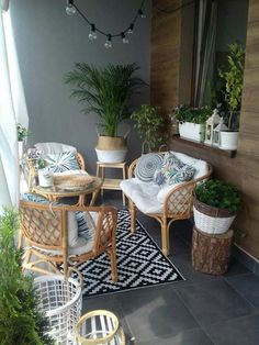 an outdoor patio with wicker furniture and potted plants