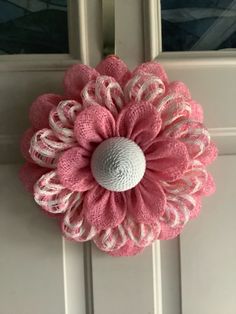 a pink and white door handle with a large flower on it's center piece