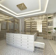 a large closet with white drawers and gold accents