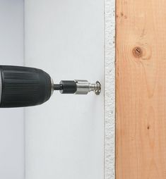 an electric drill is attached to the wall