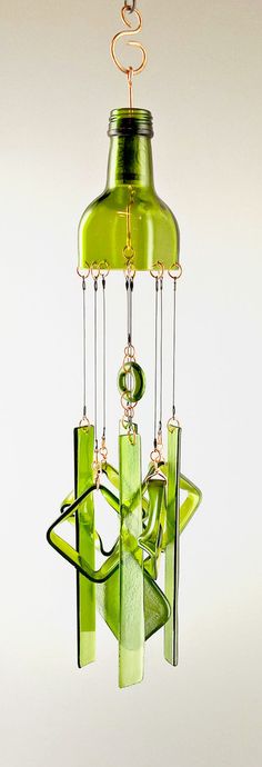 a green glass wind chime hanging from a ceiling