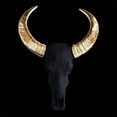 a bull's head with gold horns on a black background