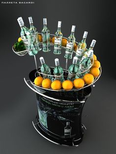 there are many bottles and oranges in the ice bucket on display for everyone to see