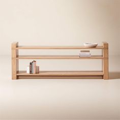 a wooden shelf with books and a bowl on top