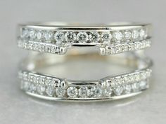 two white gold wedding rings with diamonds on each one and the other band in between them