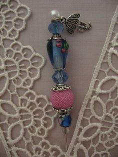 a close up of a necklace on a mannequin with beads and glass beads