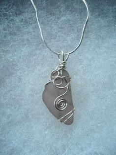 a wire wrapped pendant on a silver chain