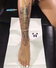 a woman's legs with tattoos on them