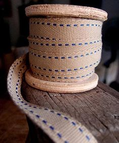 a roll of twine on top of a wooden table