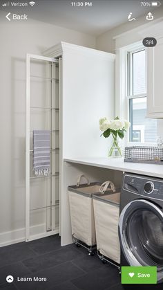 a washer and dryer in a white laundry room with open shelve