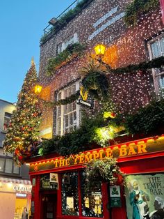 christmas decorations adorn the outside of a bar in london's covent district, england