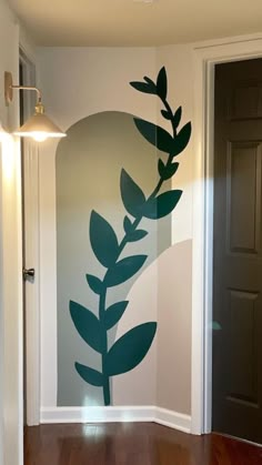 an empty room with a painted wall in the shape of a plant on it's side