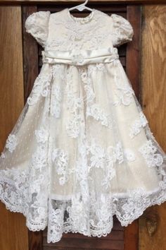 a white dress hanging on a wooden door