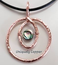 This gorgeous copper necklace is a perfect gift for your 7th Anniversary, Copper Anniversary, 22nd Anniversary, or as a gift for that special women in your life! The copper pendant has been hand hammered and then wire wrapped with a beautiful abalone shell bead and measures approximately 2 inches wide and 2 inches long. It has polished to a beautiful shine and is clear coated to protect the polished finish. It comes with an 18 inch leather cord necklace, in either black or brown (photo is shown Copper Jewelry Diy, Copper Wire Crafts, 22nd Anniversary, Wire Wrap Jewelry Designs, Hammered Jewelry, Copper Wire Jewelry, Copper Anniversary, Wire Jewelry Tutorial, Wire Jewelry Designs