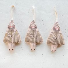 three small wooden ornaments hanging from hooks