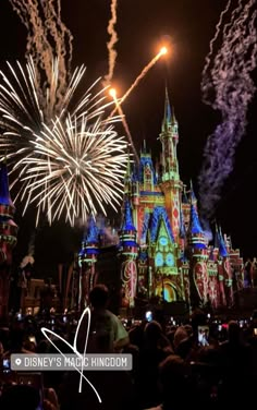 fireworks are lit up in front of the castle at disney world's magic kingdom