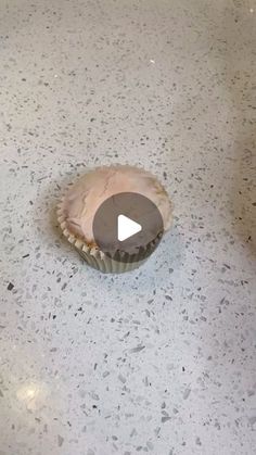 a cupcake sitting on top of a white counter