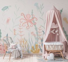 a child's room with pink and green wallpaper, an octopus bed, two chairs and a baby crib