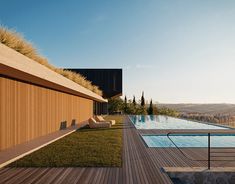 a wooden deck next to a swimming pool