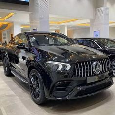 several cars are on display in a showroom