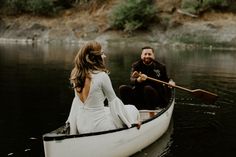 a man and woman in a canoe on the water