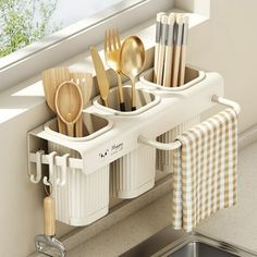 kitchen utensils and spoons are in the holder