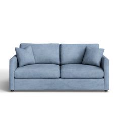 a blue couch with two pillows on it's back and one arm facing the camera