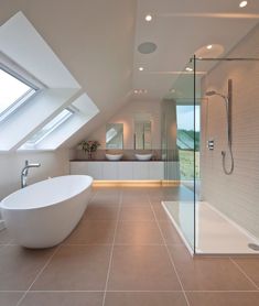 a large bathroom with a skylight above the bathtub and shower area is shown