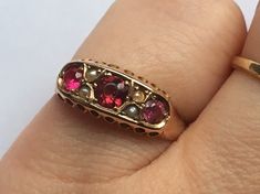 antique ruby gold ring and seed pearls ring with non catching boat setting in size O-P. very good antique condition. full hallmarks. Very good antique condition. please study images closely for inspection before purchase and ask should you have any questions. Please note: Images show the ring enlarged to provide sufficiant close up pictures. Dispatched with Royal Mail special delivery. Ornate Gold Ring With Ruby, Ornate Gold Ruby Ring, Antique Gold Ruby Ring Hallmarked, Antique Ruby Ring Hallmarked, Victorian Gold Ruby Ring With Multi-stone, Ruby Band Ring, Seed Pearl Ring, Close Up Pictures, Seed Pearl