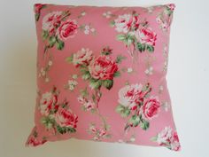 a pink pillow with roses on it