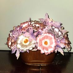 a vase filled with purple flowers on top of a wooden table