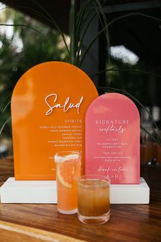 Pink and orange retro styled wedding signage beside cocktails Wedding Cocktail Ideas, Sangria Wedding, Pallet Wedding Signs, Orange And Pink Wedding, Signature Cocktails Wedding, Pallet Wedding, Cocktail Ideas, Orange Retro, Themed Drinks