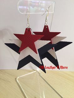 two red, white and black star shaped earrings