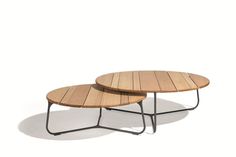 two wooden tables sitting next to each other on top of a white floor with black legs