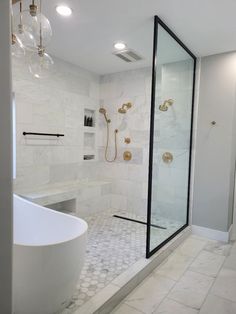 a bathroom with a tub, shower and chandelier