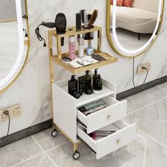 a white vanity with gold trim and drawers in front of a large mirror on the wall