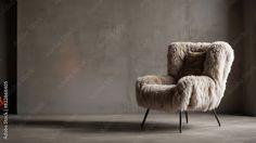 the chair is made out of sheepskin and sits in front of a concrete wall