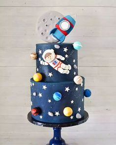 a space themed cake with an astronaut on top