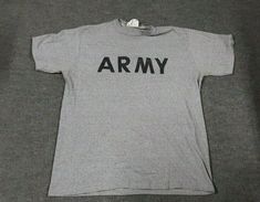 This is a vintage US Army PT T-Shirt.  This is part of the PFU, physical fitness uniform.  It is dated 1998 The Shirt is 50% Cotton, 50% Polyester SPO100-98-D-CA54 The contractor for this shirt was Unicor of Jesup, GA This is a size Large The approximate measurements are:    Pit to Pit: 22"    Length: 27" Please see photos for details and ask any questions before purchasing. We do not ship internationally. *Be sure to check out my other items for sale* Army T Shirt, Gray Fashion, Army Shirts, Usa Print, Summer Body, Mens Vintage, Physical Fitness, Gray Tshirt, Funny Design