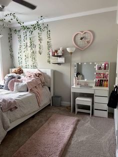 a bedroom with a bed, desk and mirror