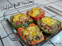 four stuffed bell peppers in a glass baking dish