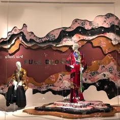 two mannequins dressed in traditional chinese clothing and one is wearing a kimono