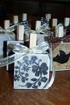 small wooden blocks with black and white designs are tied to clothes pegs on a table