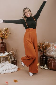 The Setting Trends Suspender Pants in Rust are a trendy and stylish choice for your wardrobe. These suspender pants are perfect for a 30-something mama who loves boutique fashion and wants to make a fashion statement. These pants are a surefire way to set trends and show off your fashion-forward style. Solid Paper Bag High-waist Wide Leg Suspender Pants Wide legs Full length Wide banded high waist Side hidden pockets Made in the USA Inseam: Small 30 in Medium 30.50 in Large 30.75 Rise: Small 15. Orange Trousers Outfit, Orange Trousers, Colored Pants Outfits, Pant Outfits For Women, Trousers Outfit, Trouser Outfit, Rusty Orange, Suspender Pants, Color Pants